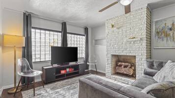 Smart TV, fireplace, books, printers