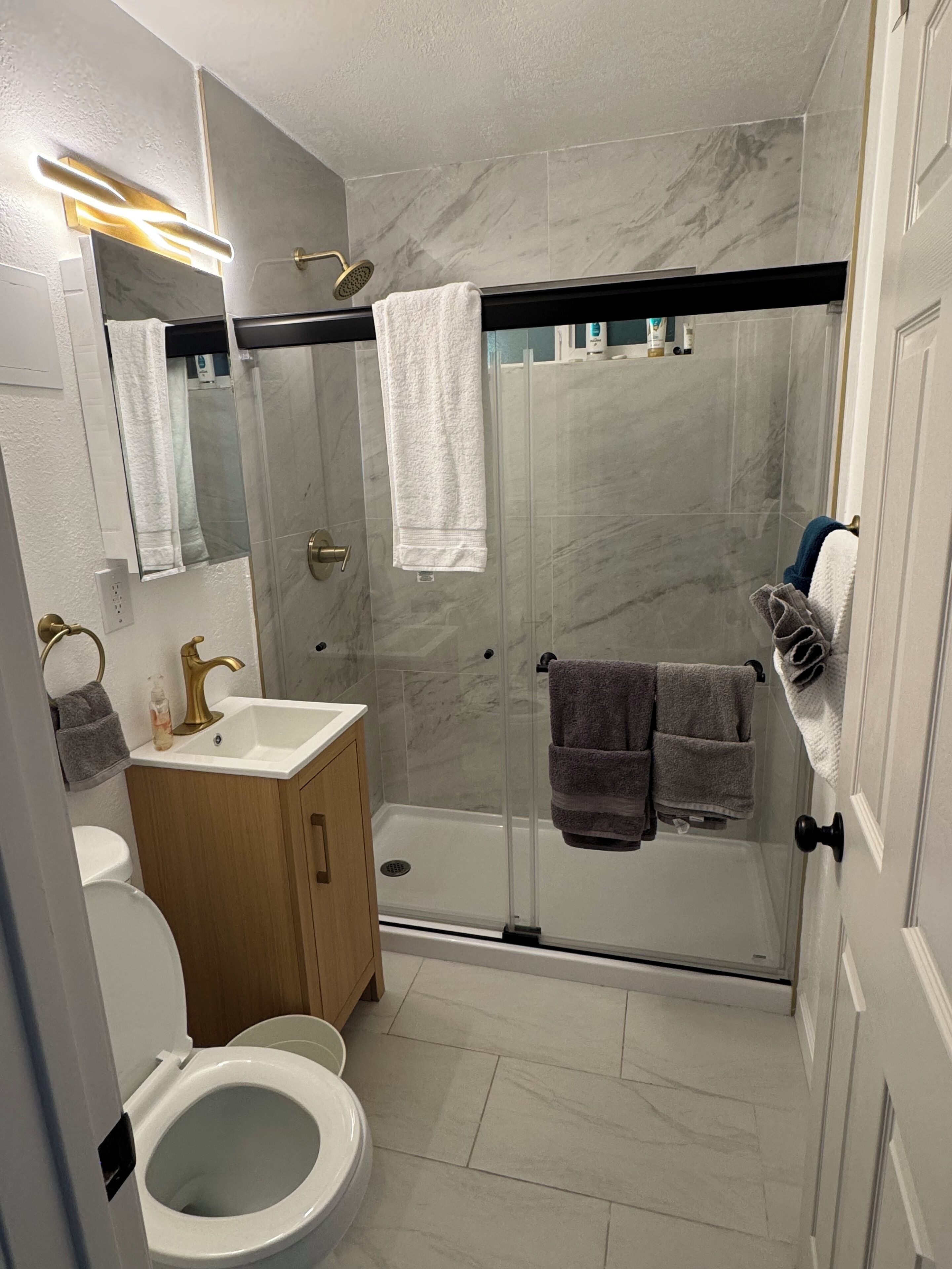 Shower, hair dryer, towels, soap