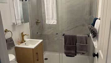 Shower, hair dryer, towels, soap