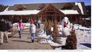 A lodge with a covered walkway and snow-covered roof, surrounded by potted evergreen trees. - Luxury Evergreen Retreat · Fireplace · Mountain Views · 45 min Denver  (Evergreen)