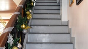 A staircase with a railing decorated with Christmas ornaments and garlands.
