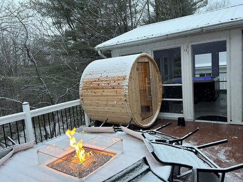 Features two living rooms, sauna, hot tub, and fire pit -over 4 acres of land.