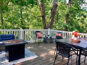 A deck with outdoor furniture, including a sofa, chairs, and a table. - Mountain Dreams (Massanutten)