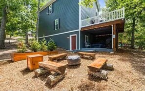 A house with a deck and a fire pit area with benches. - Mountain Dreams (Massanutten)