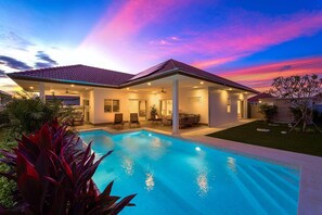 A two-story house with a swimming pool, covered patio, and a garden. - New Private Pool Villa with 3BR MV77 (Hua Hin)