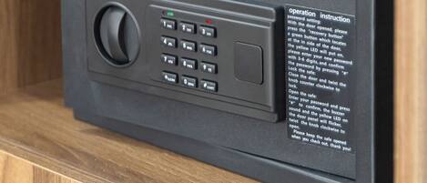 A black security keypad with a green LED indicator and a "HOMESUN" label, mounted on a wooden surface.