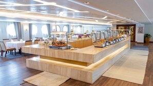 A modern hotel lobby with a central buffet area, wooden flooring, and a seating area with tables and chairs. - Sonesta Sun Goddess Nile cruise ship - 4 & 7 nights - From Luxor every Monday (Luxor)