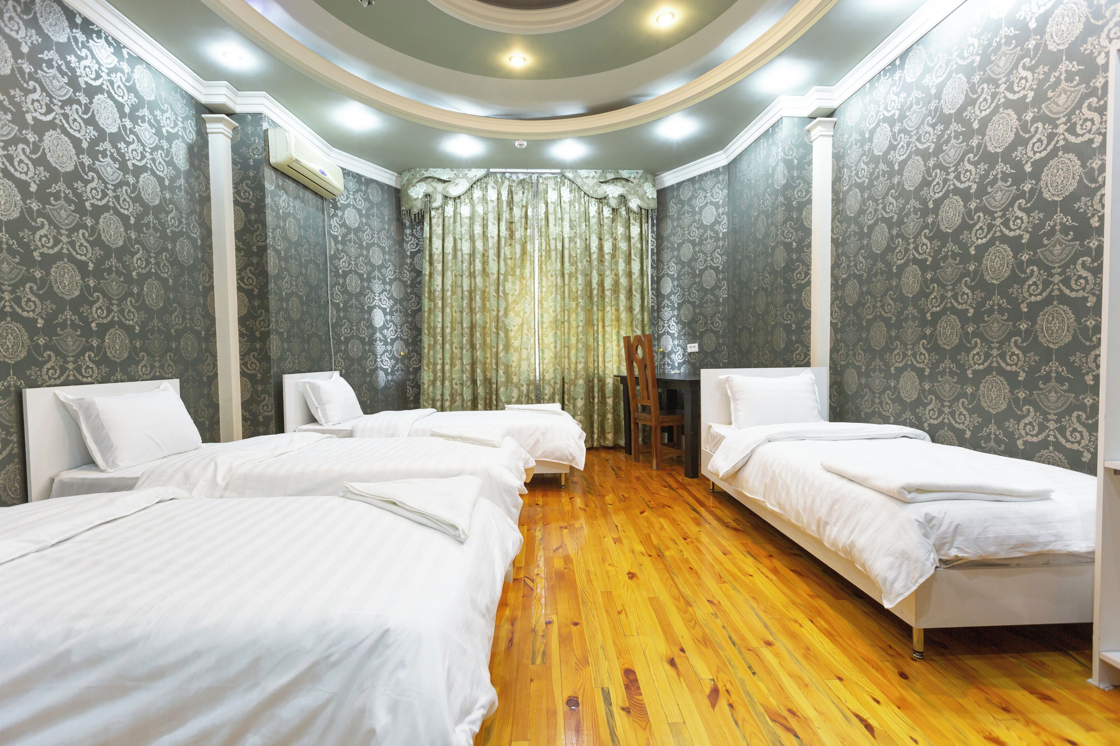 Economy Quadruple Room, Courtyard View | Laptop workspace, blackout drapes, iron/ironing board, free WiFi