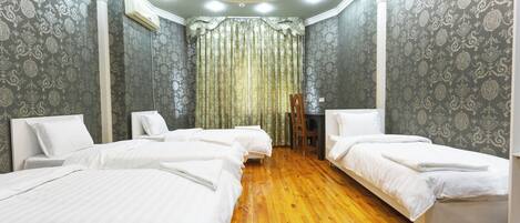 Economy Quadruple Room, Courtyard View | Laptop workspace, blackout drapes, iron/ironing board, free WiFi