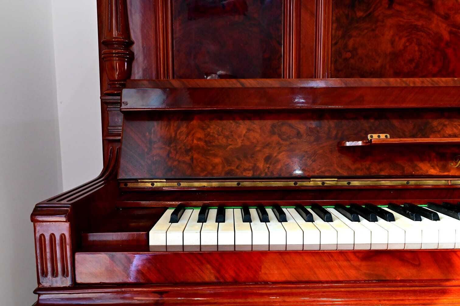 Un piano à queue doté d’une finition en bois brillante et d’un clavier noir et blanc.