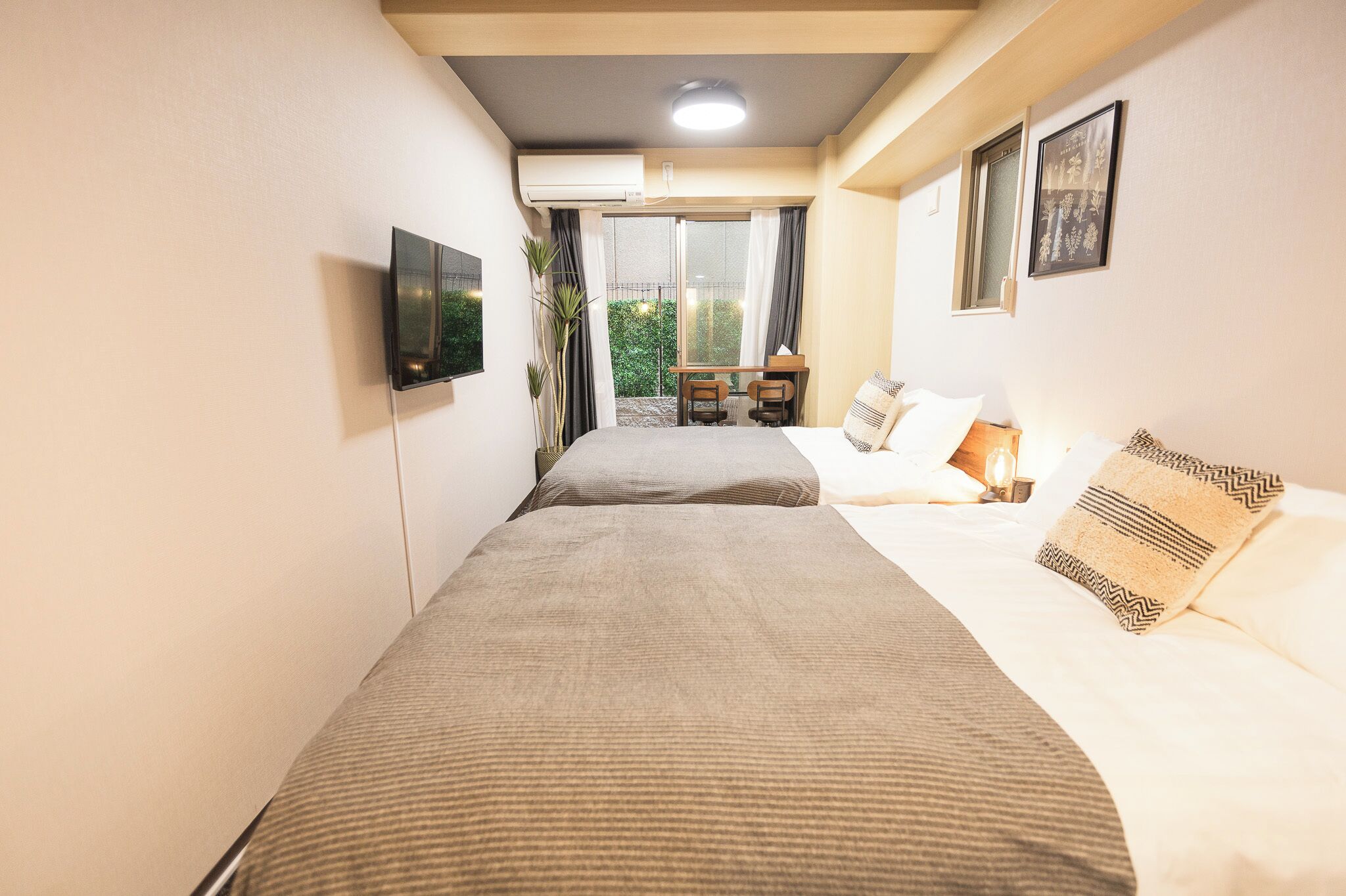 Une chambre d’hôtel avec un lit, un bureau, une chaise et un téléviseur.
