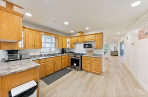 A kitchen with wooden cabinets, a stainless steel range, and a microwave.
