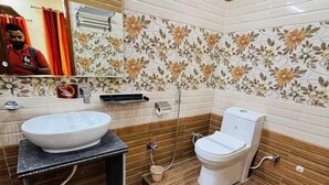A bathroom with a sink, toilet, and shower.