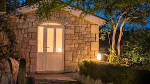 Un edificio de piedra con una puerta y un pequeño porche.