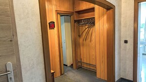 Un placard en bois avec une étagère en métal et une porte portant une inscription.