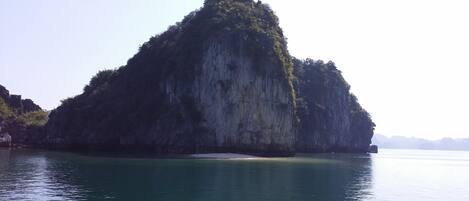 A large, isolated limestone island surrounded by calm water.
