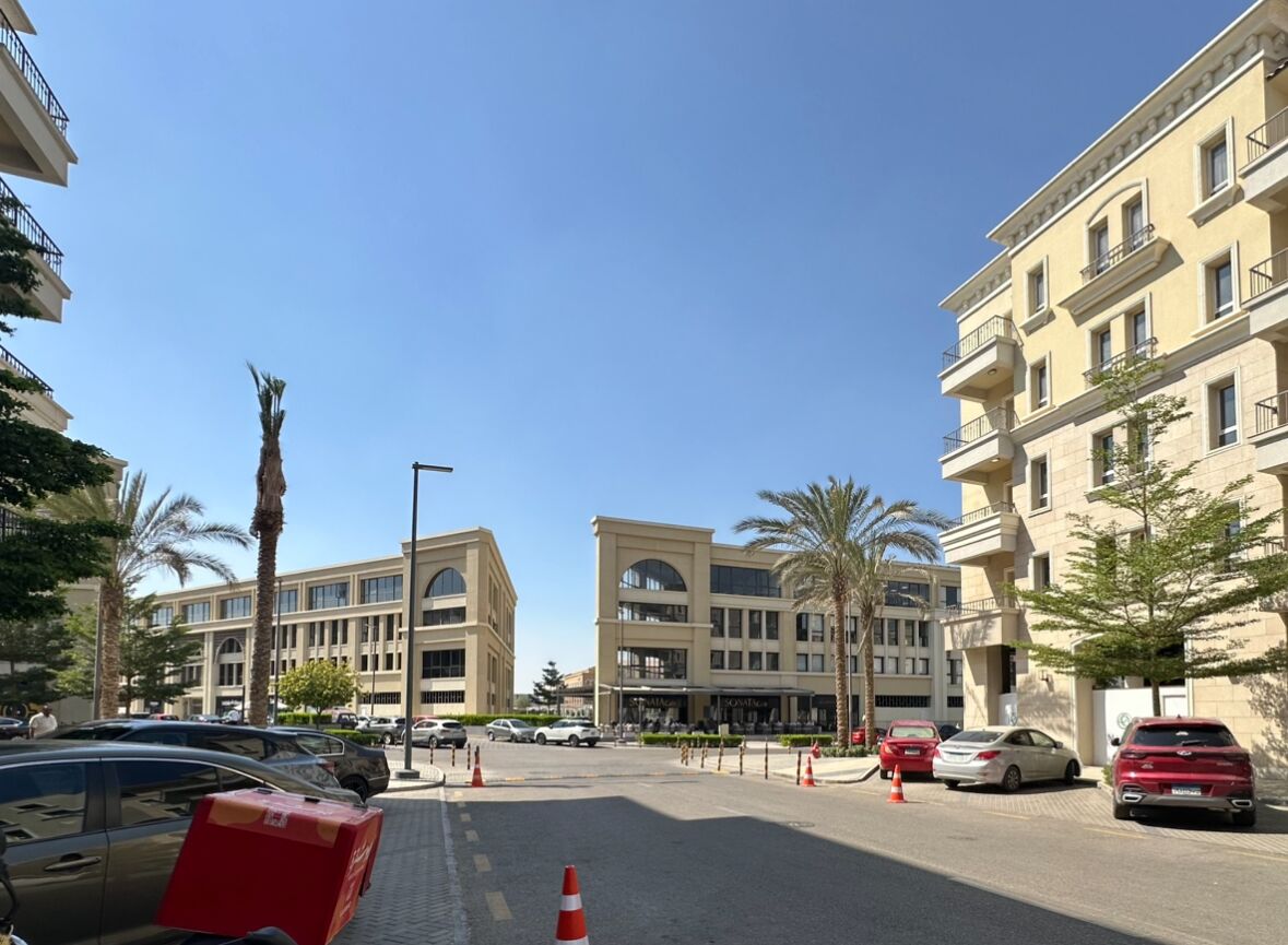 A multi-story building with a modern architectural style, featuring balconies and large windows.