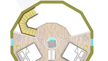 A floor plan of a hotel with a central circular area, two bedrooms, a bathroom, and a kitchen.