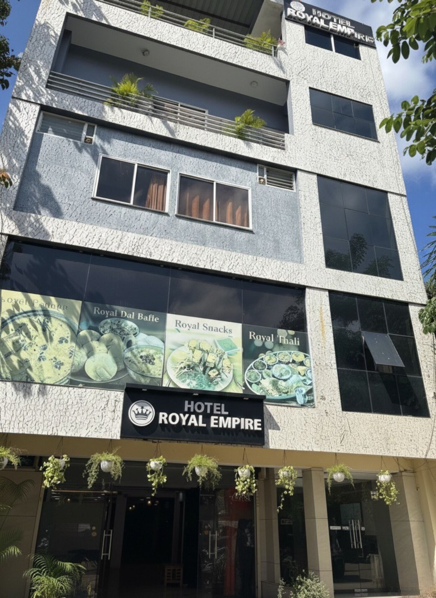 A multi-story building with a sign for 'Hotel Royal Empire'.