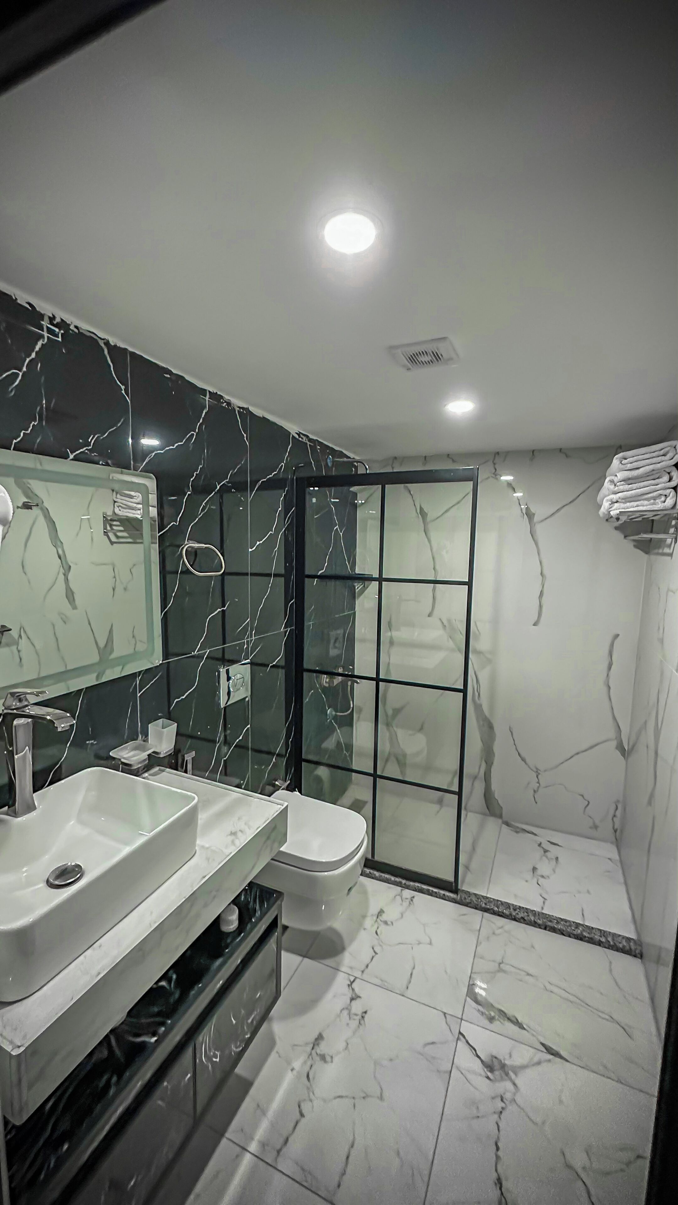 Separate bathtub and shower, towels, soap, shampoo