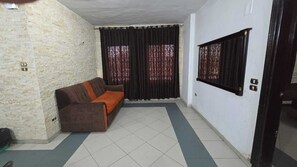 Deluxe Double or Twin Room, City View | Living area | Flat-screen TV