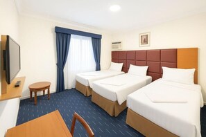 A hotel room with two single beds, a TV, a small table, and a chair. - Jawaher Al Bait 2 Hotel Makkah by Moro (Makkah)