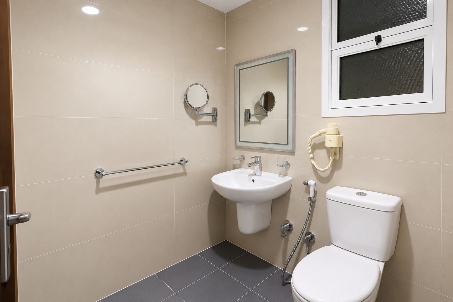A bathroom with a toilet, sink, and mirror.