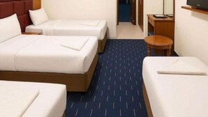 A hotel room with two beds, a TV, and a small table. - Jawaher Al Bait 2 Hotel Makkah by Moro (Makkah)
