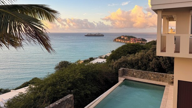 A pool with a view of the sea and a cruise ship in the distance. - 5BR Hilltop Villa! Pool & Ocean Views (Sint Maarten)