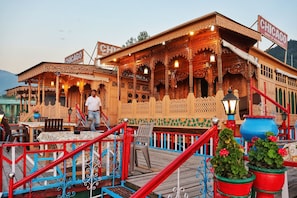 A wooden building with intricate carvings and a sign that reads "CHICAGO". - Chicago Houseboats  (Srinagar)