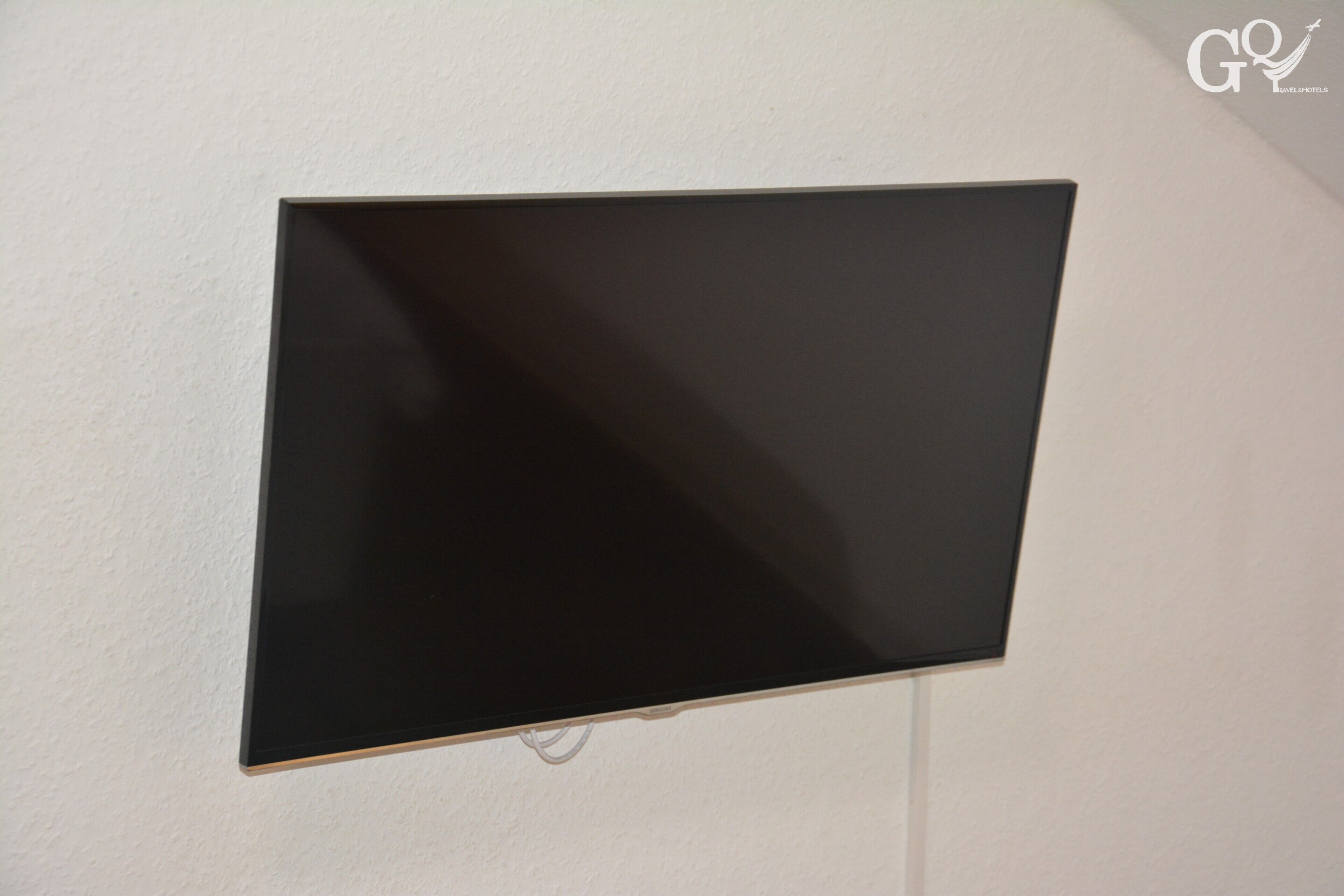A flat-screen TV mounted on a plain wall.