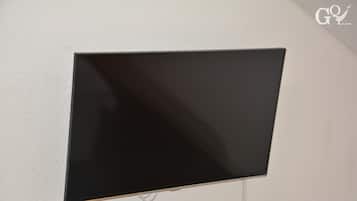 A flat-screen TV mounted on a plain wall.