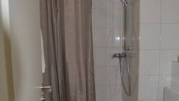 Deluxe Studio Suite | Bathroom | Shower, hair dryer, slippers, towels