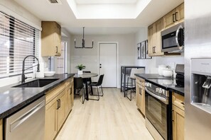 Fridge, microwave, oven, stovetop - Welcome to your modern North Scottsdale escape—3BR, 2BA with 2 king beds and 1 queen. Enjoy a cozy fire pit, fenced yard, BBQ, and community pool, all minutes from TPC Scottsdale, spring training, hiking, dining, and Old Town nightlife. (Scottsdale)