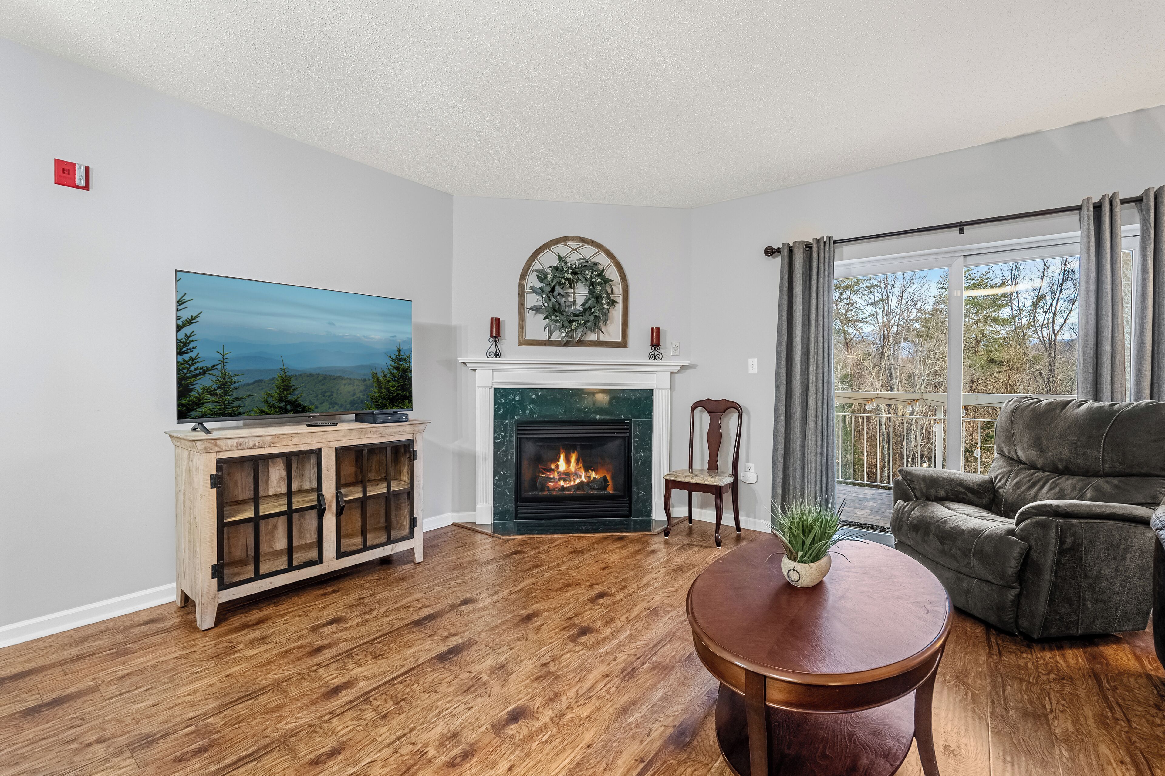 A living room with a fireplace, a television, and a sofa.