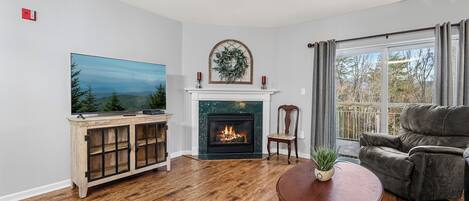 A living room with a fireplace, a television, and a sofa.