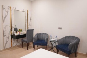 Executive Quadruple Room, 2 Queen Beds | Living area | TV