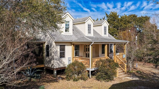 A two-story house with a porch and a small deck. - Stay Salty: Recently Renovated Historic Home l Centrally Located I Pet Friendly (Ocracoke)