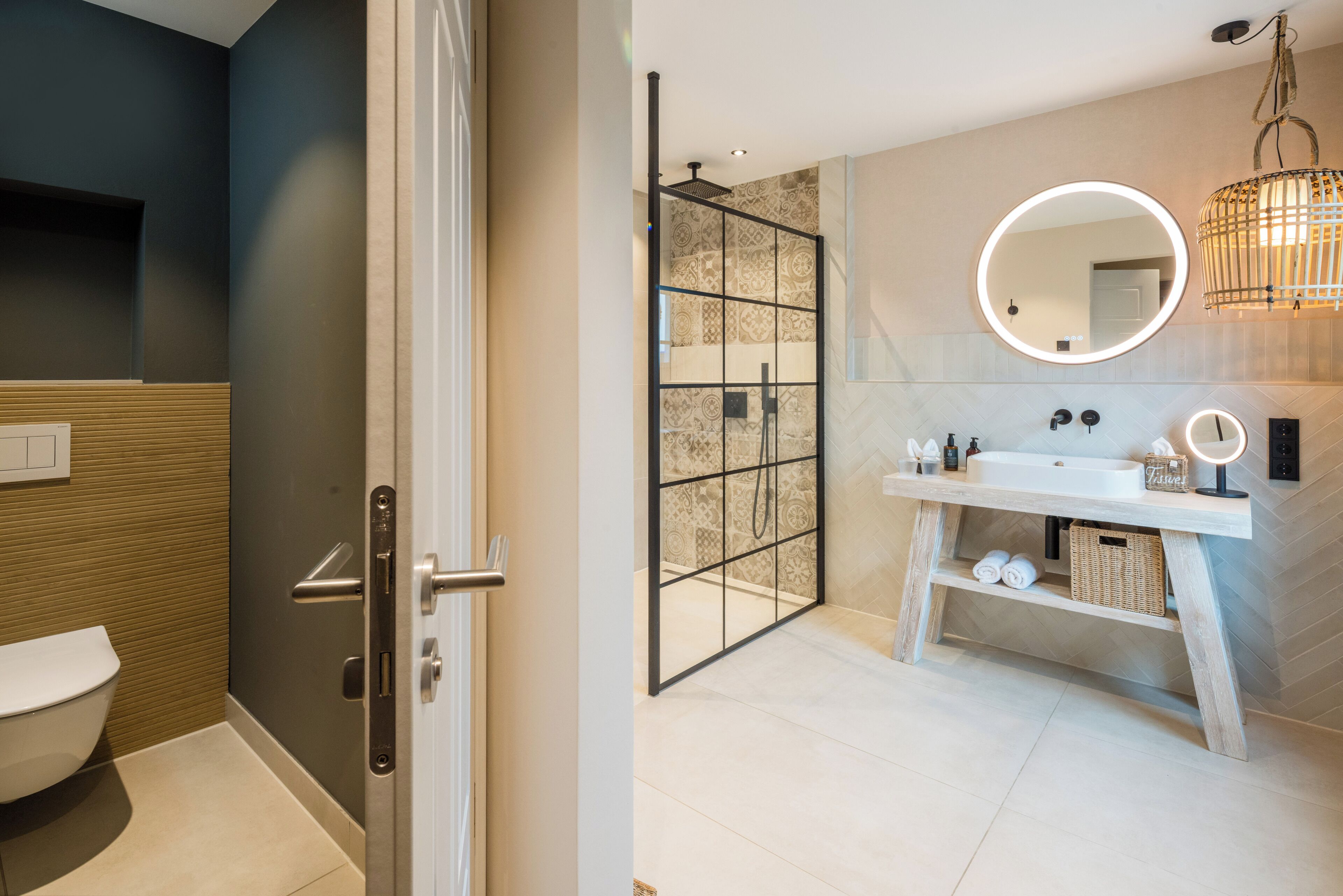 A modern bathroom with a toilet, shower, and vanity with a mirror.