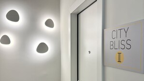 A modern interior with a door, recessed lighting, and a sign reading "CITY BLISS II".