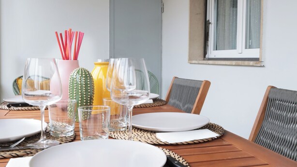 A dining table set with plates, glasses, and a cactus centerpiece. - Tuscany Best Point [30 min by train to Florence] (Stazione)