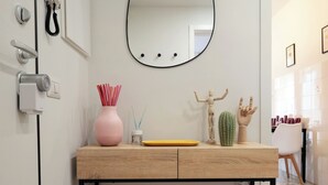 A modern bathroom with a wooden vanity, a round mirror, a cactus, and a hand-shaped soap holder. - Tuscany Best Point [30 min by train to Florence] (Stazione)