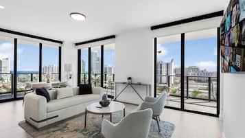 Luxury Condo, Balcony, City View | Living area | 10-inch Smart TV with cable channels