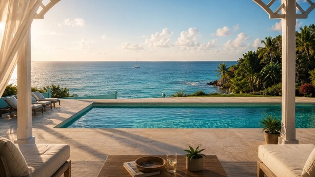 A poolside area with a view of the ocean, lounge chairs, and a pergola. - Turtle Cove House by Le Haus (St. John's)