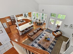 A spacious open-plan living area with a kitchen, dining space, and a staircase.