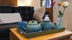 A tray with tea set and flowers on a wooden table. - Aethelred Annexe - New Build with Full Amenities (Winchester)