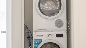 A compact, white Bosch washing machine with a top-loading door and a control panel.