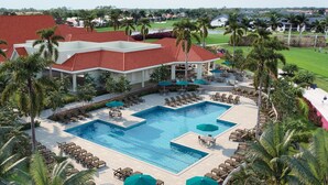 A resort with a large pool, lounge areas, and palm trees. - Countryside Golf and Country Club 2bed 2bath all new Clubhouse & facilities (Naples)