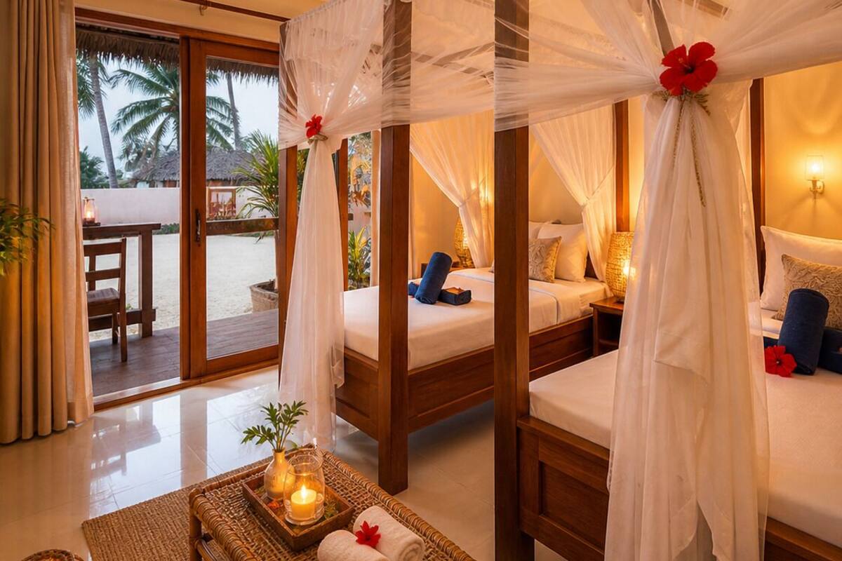 A room with a bed, a table with candles, and a view of palm trees.