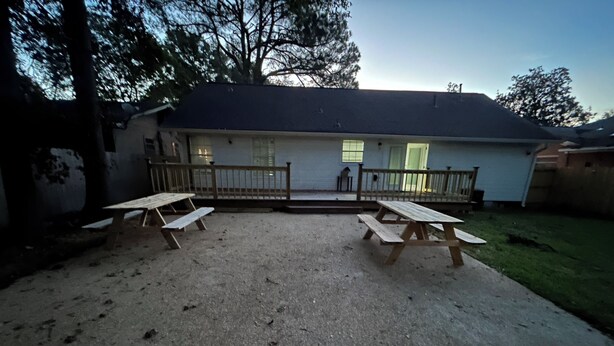 A house with a covered patio, two picnic tables, and a fenced yard. - Newly Remodeled Home with Full Deck and Gazebo. (Jackson)